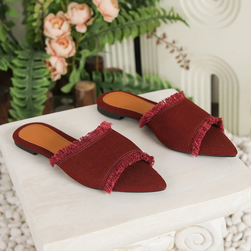 Women's denim casual flat slippers with a tassel detail in multiple colour options.