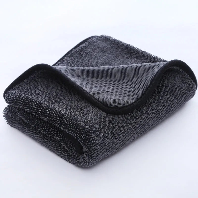 Grey car cleaning towel with red edge trim showing braided texture, laid flat to show dimensions