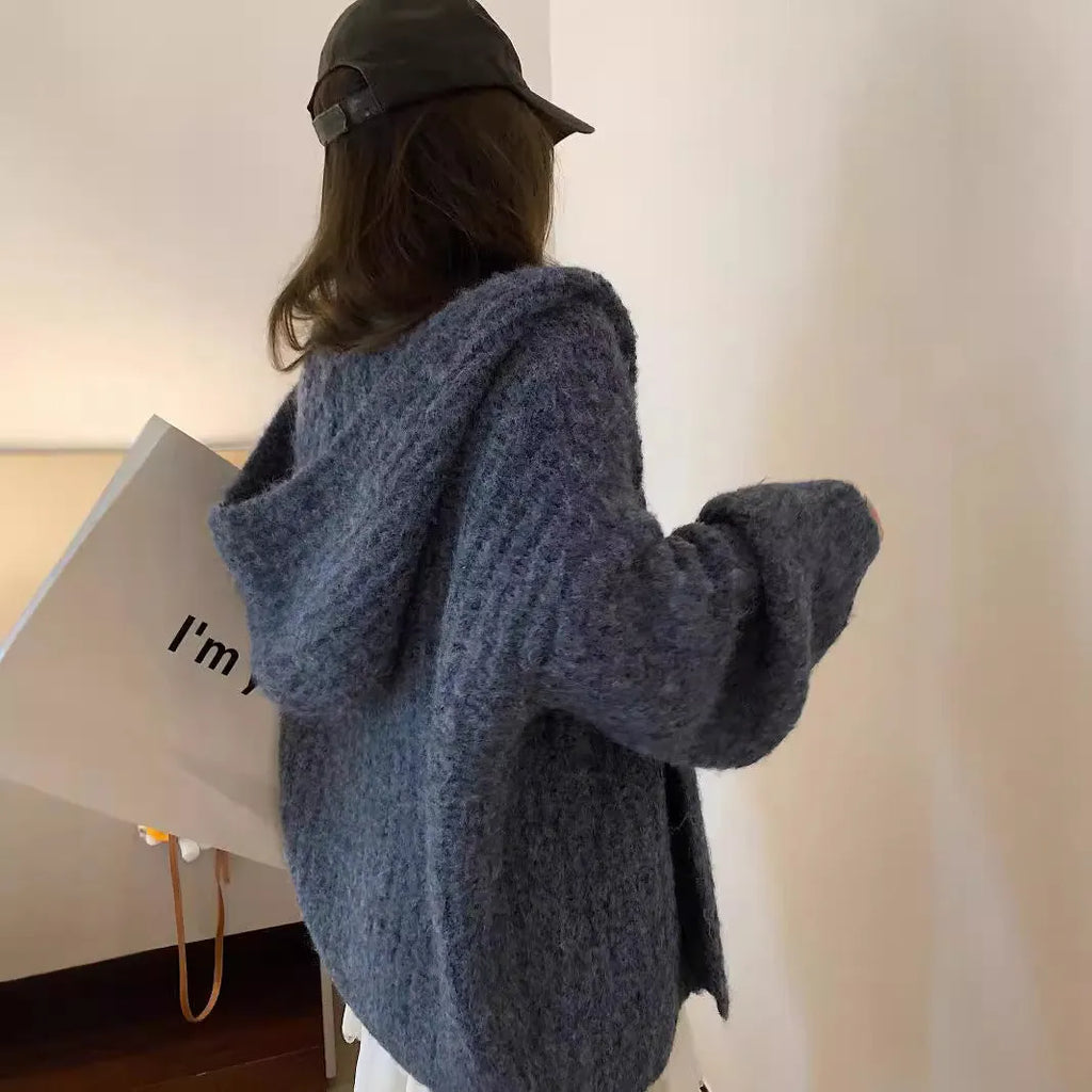 A woman's dark grey hooded cardigan with long sleeves, shown open in a loose fit.