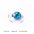 Geometric glass turtle ornament in a modern style with a coloured shell, displayed on a desktop.
