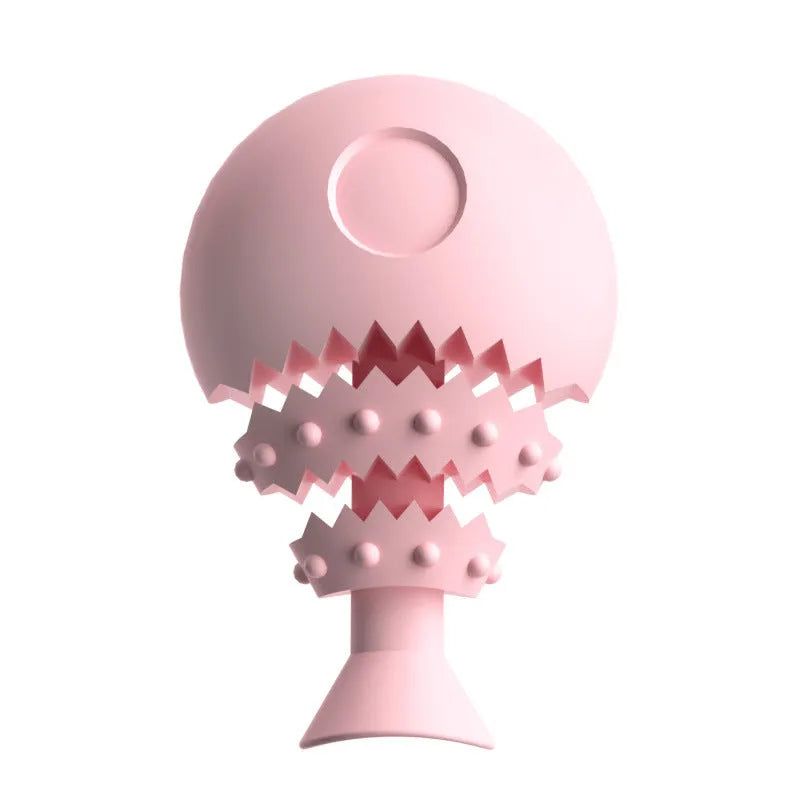 Blue green and pink fish bone shaped silicone dog chew toy with a visible hole in the base