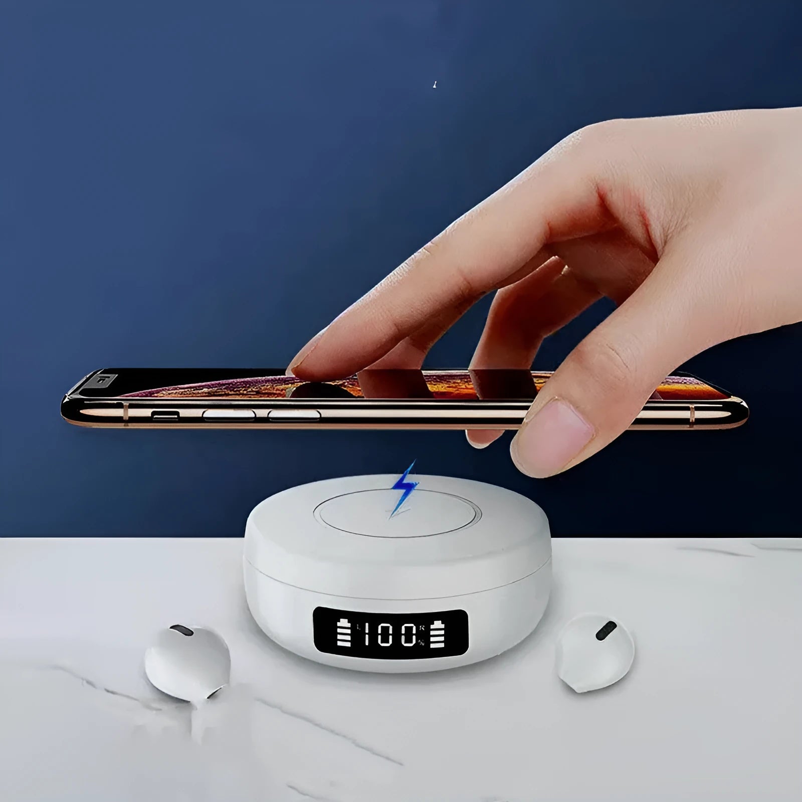 Mini black and white semi-in-ear wireless headphones with their charging case on a table.