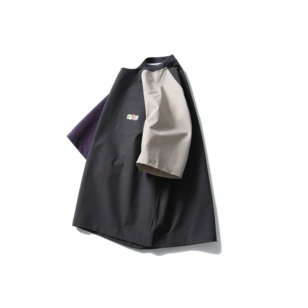 Dark grey loose-fit t-shirt with contrast colour raglan short sleeves on a hanger.