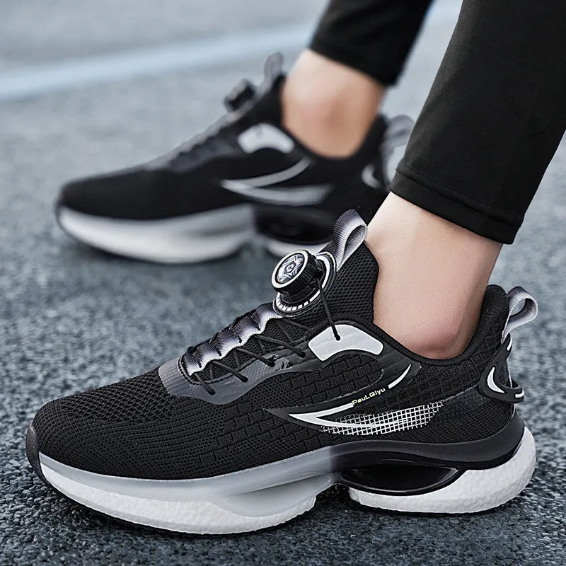 White low-top running shoes with a rotating buckle closure and Fly-knit mesh upper.