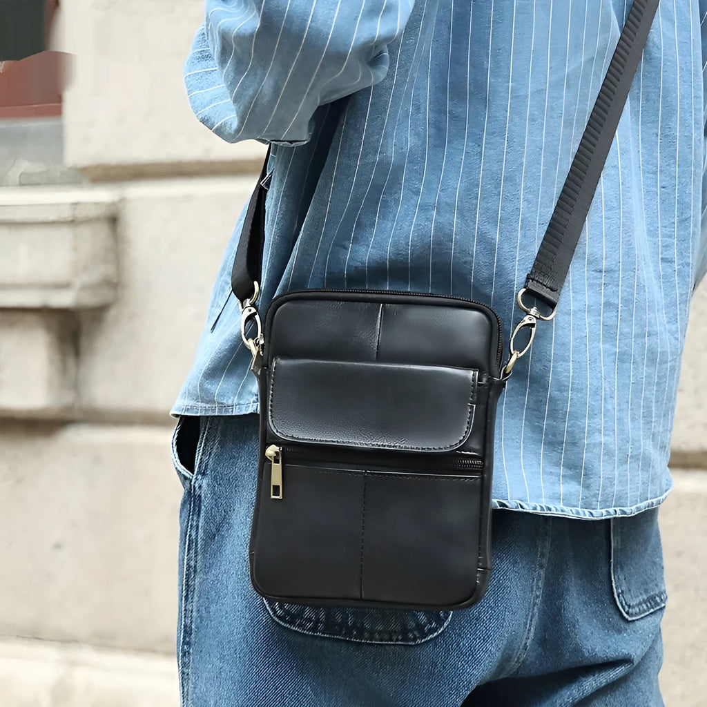 Men's brown genuine leather crossbody shoulder bag showing sewing line details.