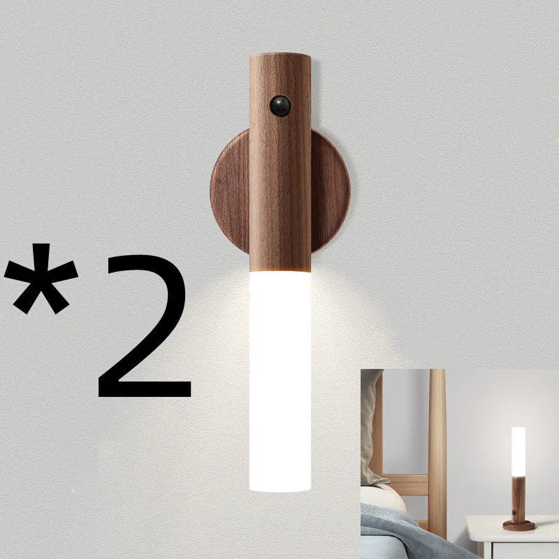 Smart sensor LED desk lamp with solid wood base and clear acrylic shade on a wooden table.