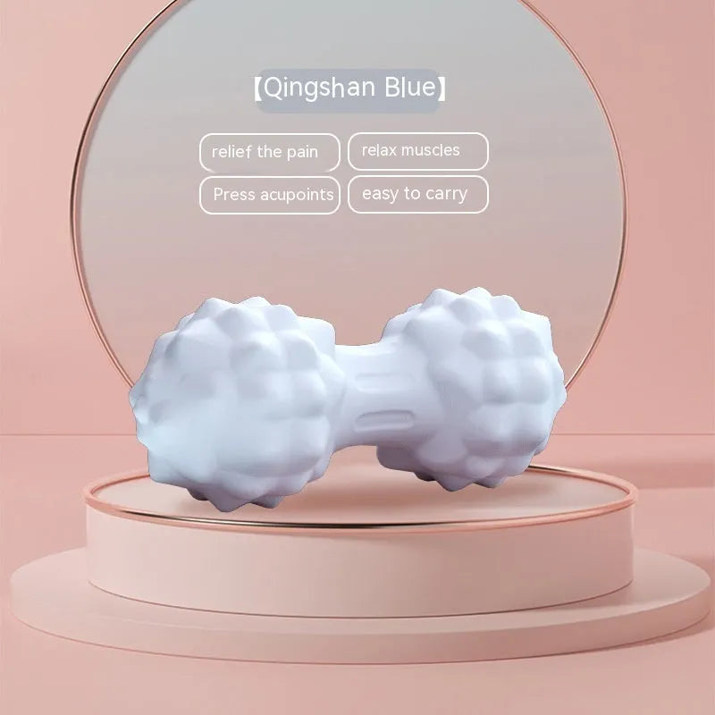 Blue peanut-shaped TPR foot massage ball on a wooden floor.