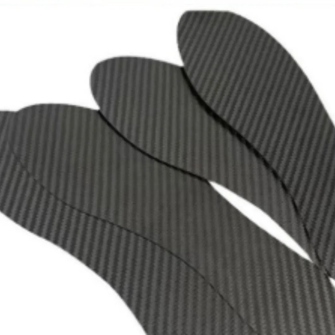 A pair of thin, black 3K carbon fibre running insoles showing the textured weave pattern, placed next to a running shoe.