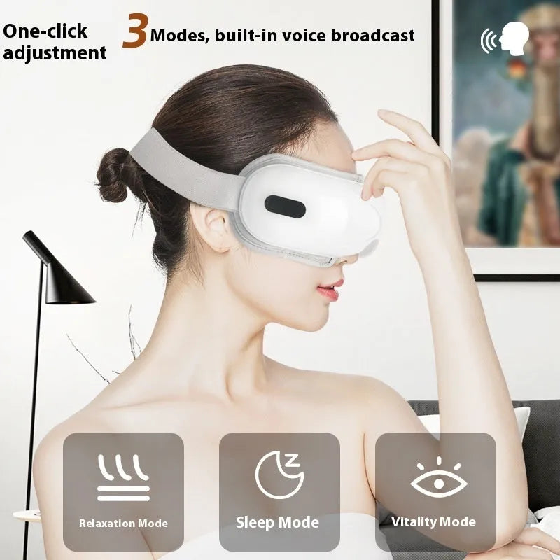 White rechargeable eye massager with airbag massage and hot compress functions on a plain background