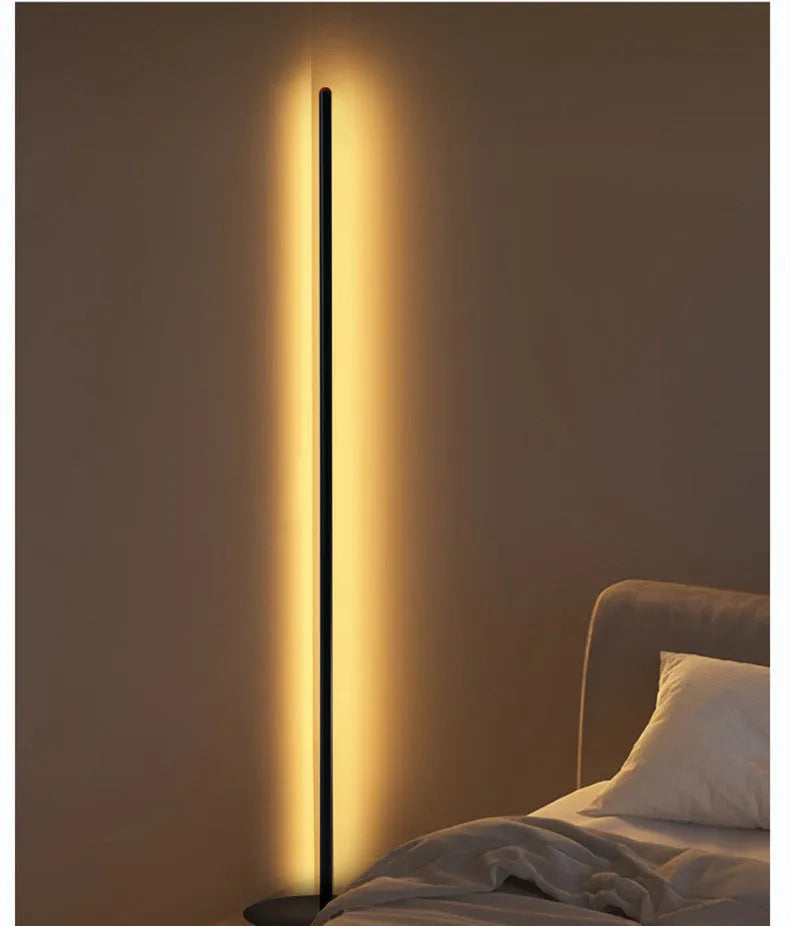 A tall, vertical aluminium alloy floor lamp with a modern design on a simple base.