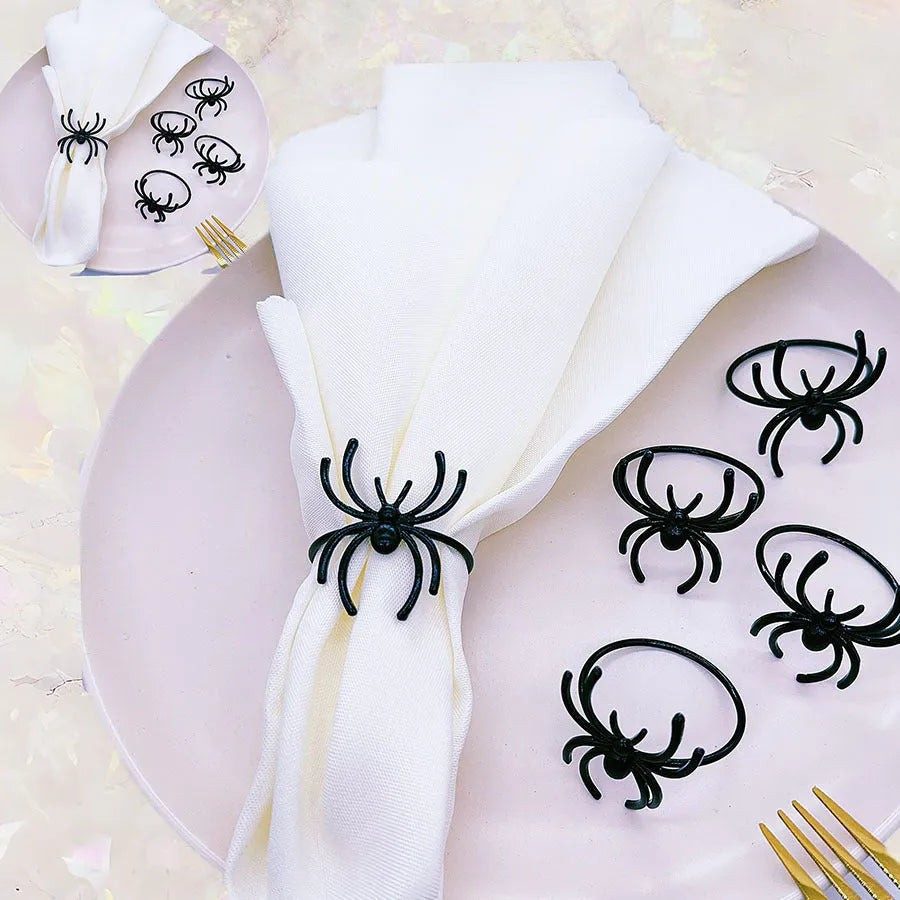 Set of six black alloy spider-shaped napkin rings for Halloween table decoration